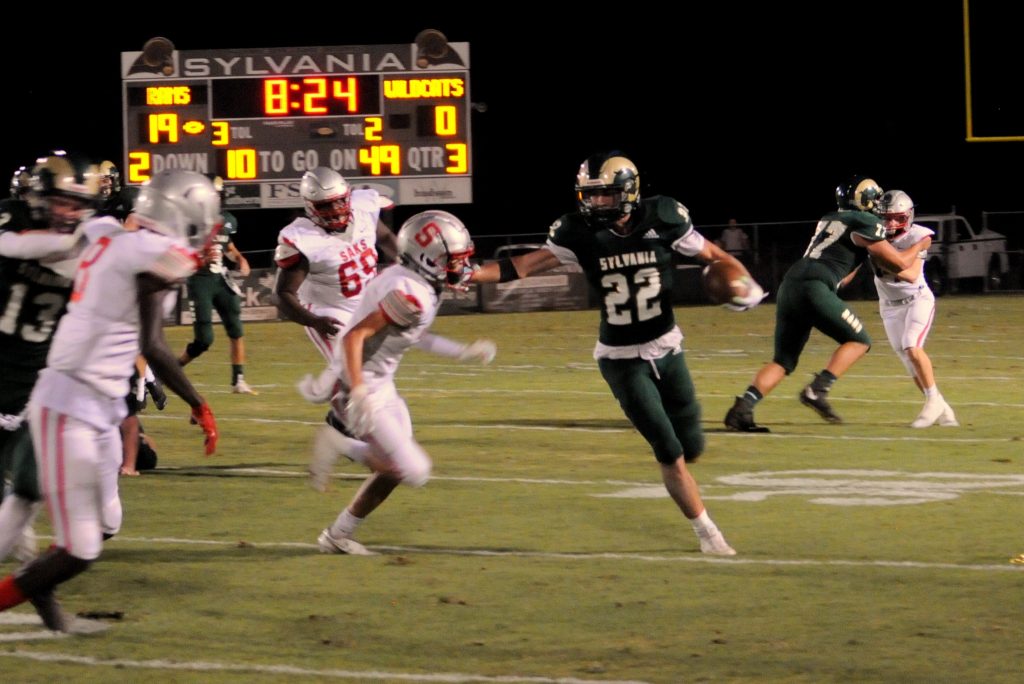 Sylvania running back Braiden Thomas carries the ball against Saks